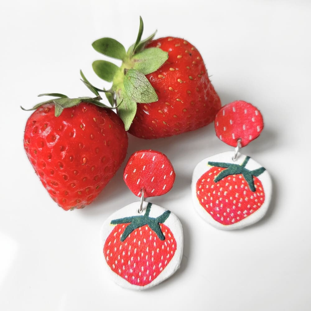 Dangly earrings with a bright, strawberry pattern