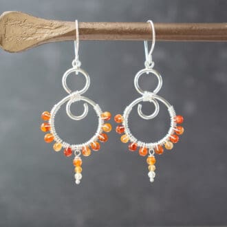 silver swirl dangle earrings with carnelian beads wire wrapped around