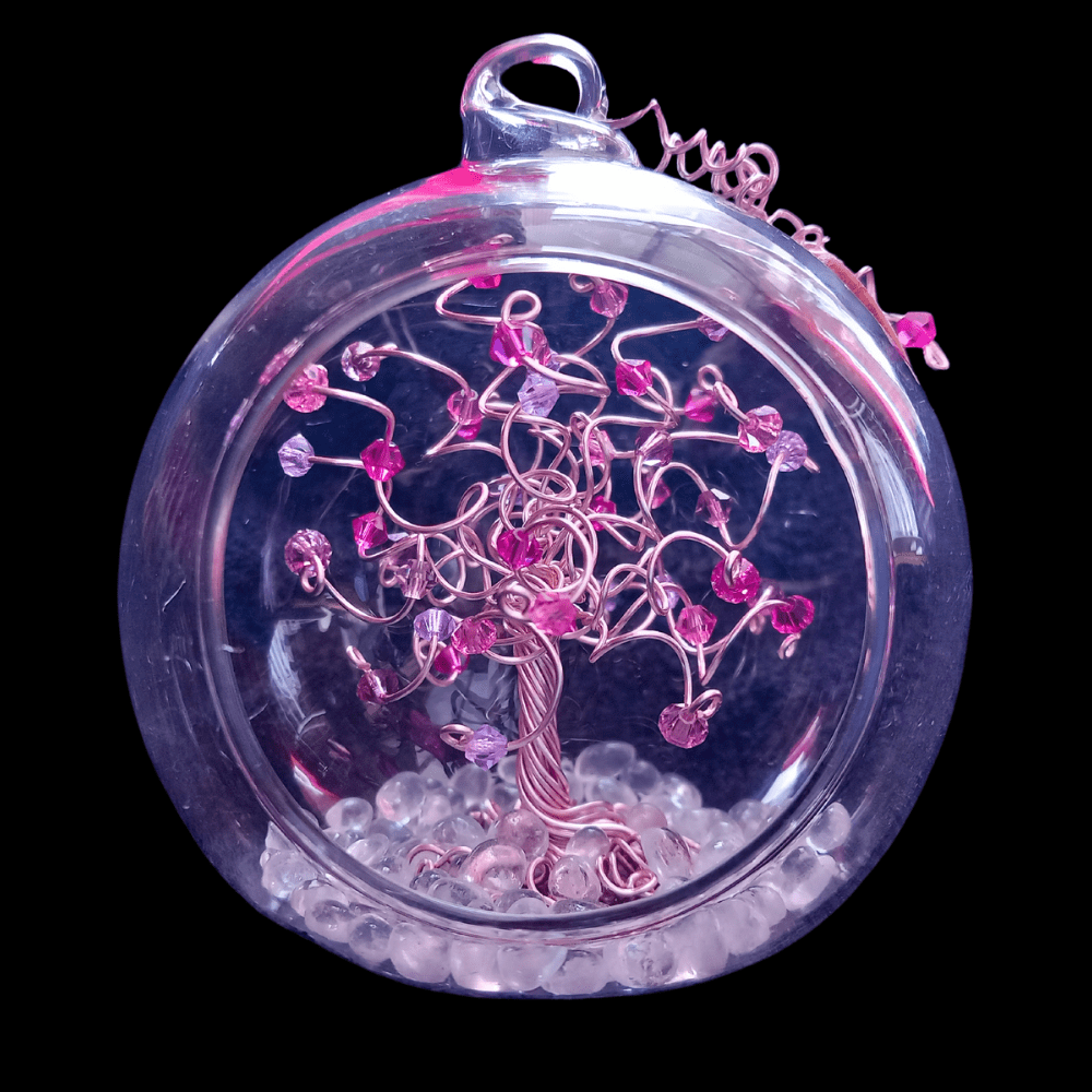 8cm glass open fronted bauble with a rose gold wire tree set inside on a glass pebble base. The branches are decorated with a fuschia, rose and violet mix crystals.