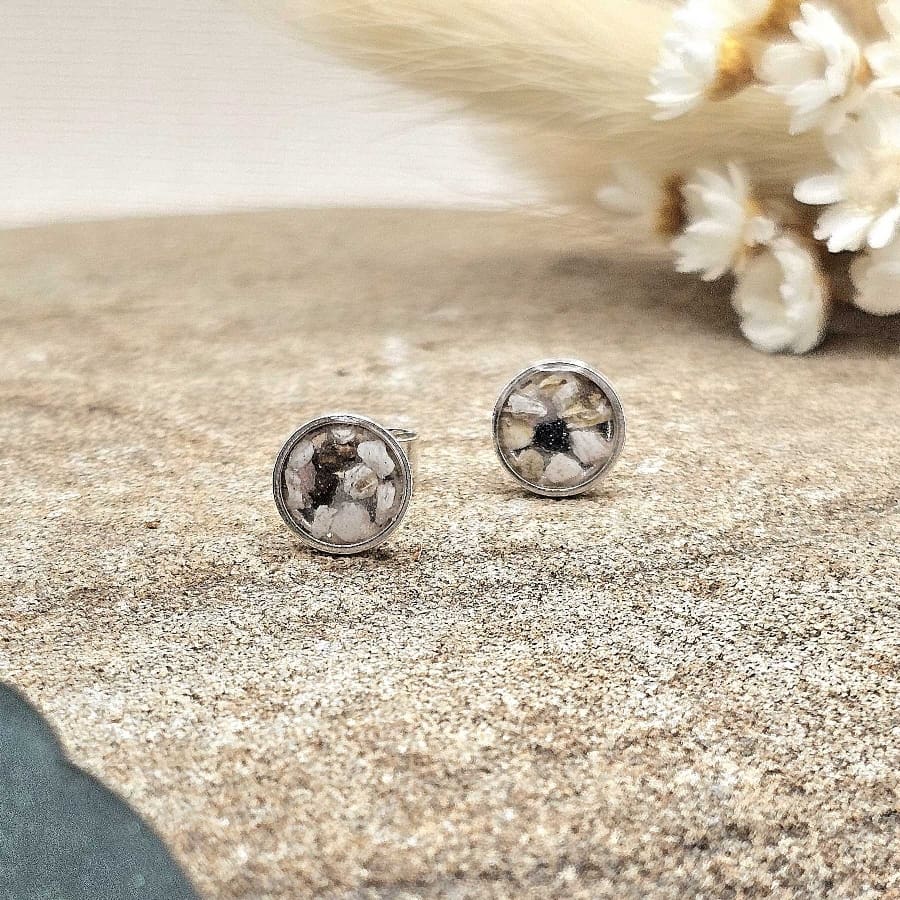 handmade small round sterling silver keepsake stud earrings displayed on decorative flat stone for online shop image