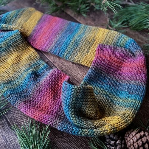 Knitted infinity loop scarf in soft shades of an Autumn rainbow