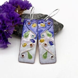 long oblong drop earrings decorated with cloisonné enamel in a naturalistic pattern with blue background on silver ear wires