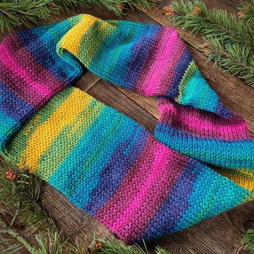 Knitted vegan rainbow infinity scarf in shades of blues, pinks, greens and gold