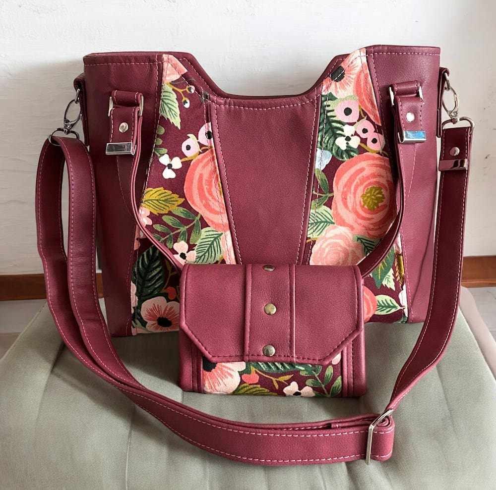 burgundy faux leather and floral canvas handbag shown with matching purse