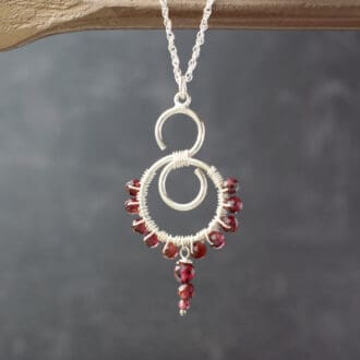 silver swirl necklace with garnet beads