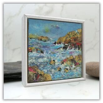 Small framed painting of coastal landscape