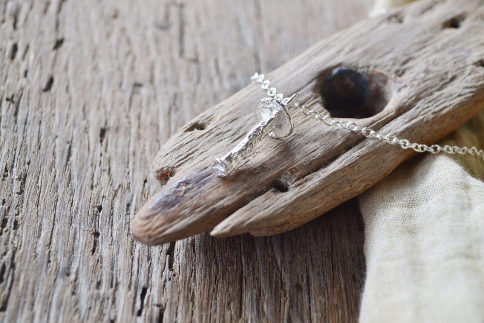 Solid silver mushroom pendant on a silver chain.