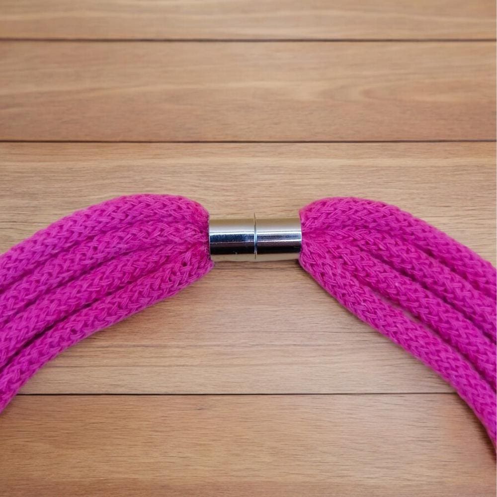 Close up of magnetic clasp feature on chunky pink cord statement necklace.