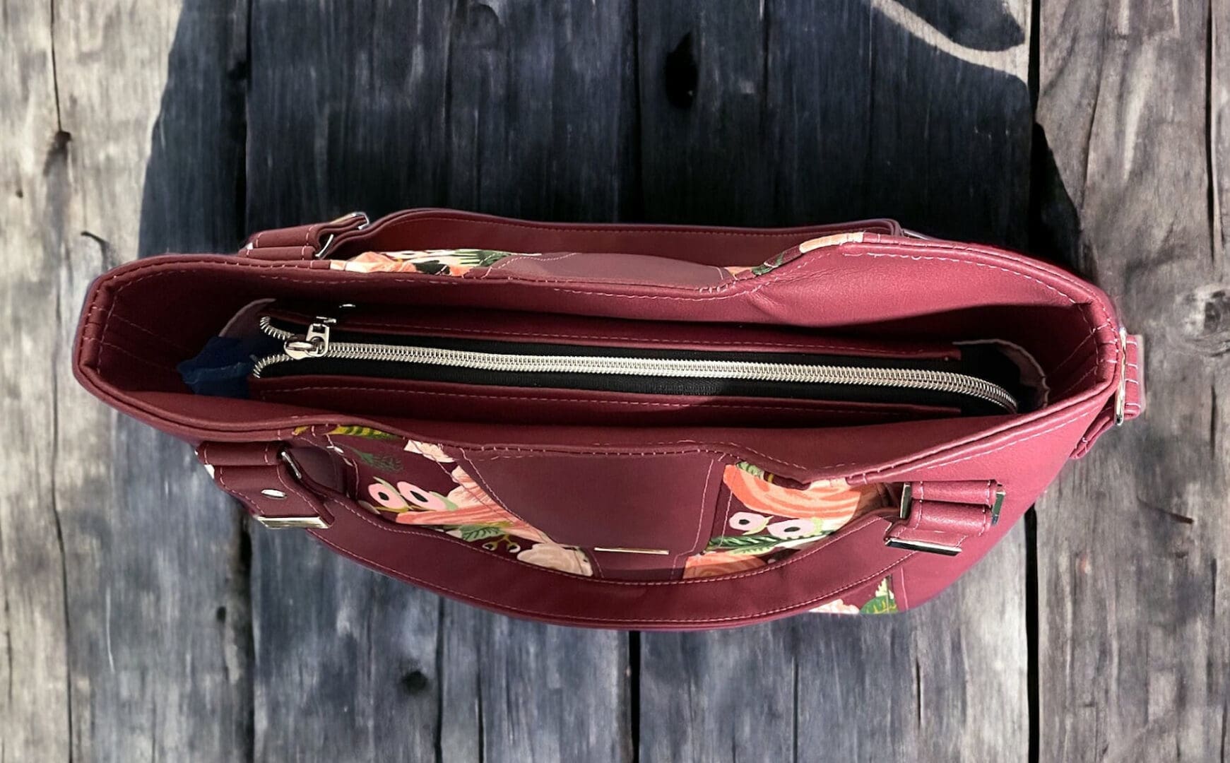 womens handbag in burgundy faux leather showing top zip closure