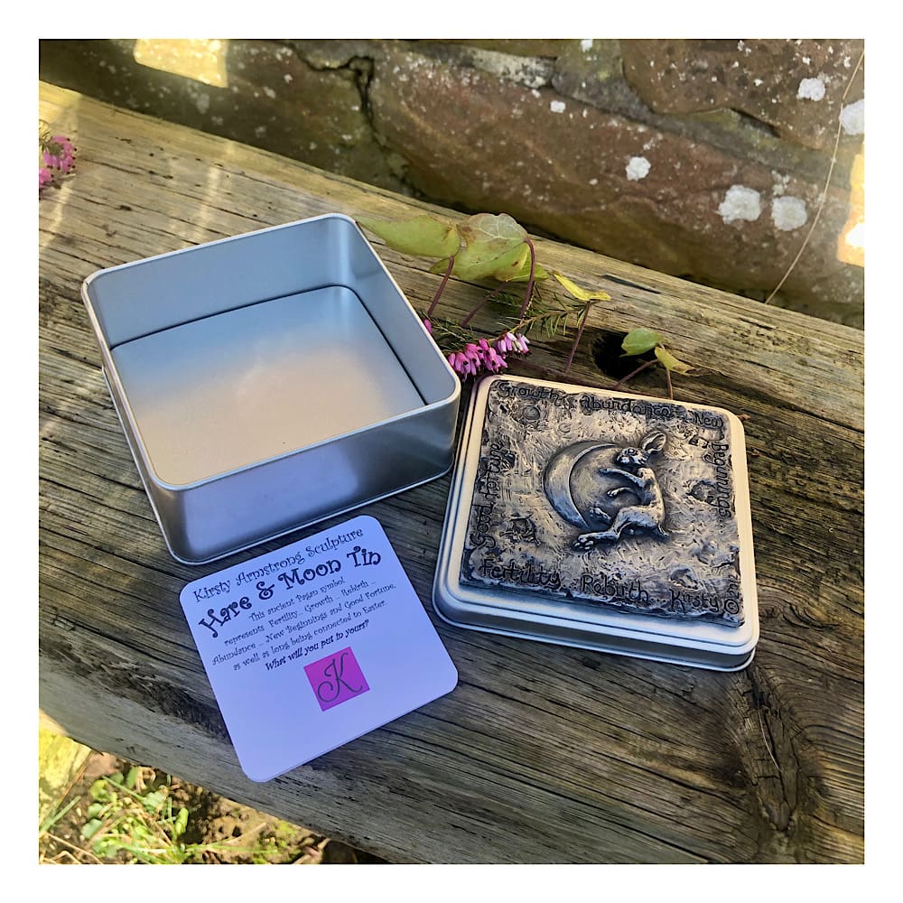 Square tin plate tin with a raised relief sculpted design in cold-cast pewter showing a Hare and Moon and the words associated with this pagan symbol. By Kirsty Armstrong Sculpture