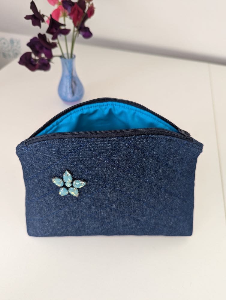 A medium size make up bag in quilted denim