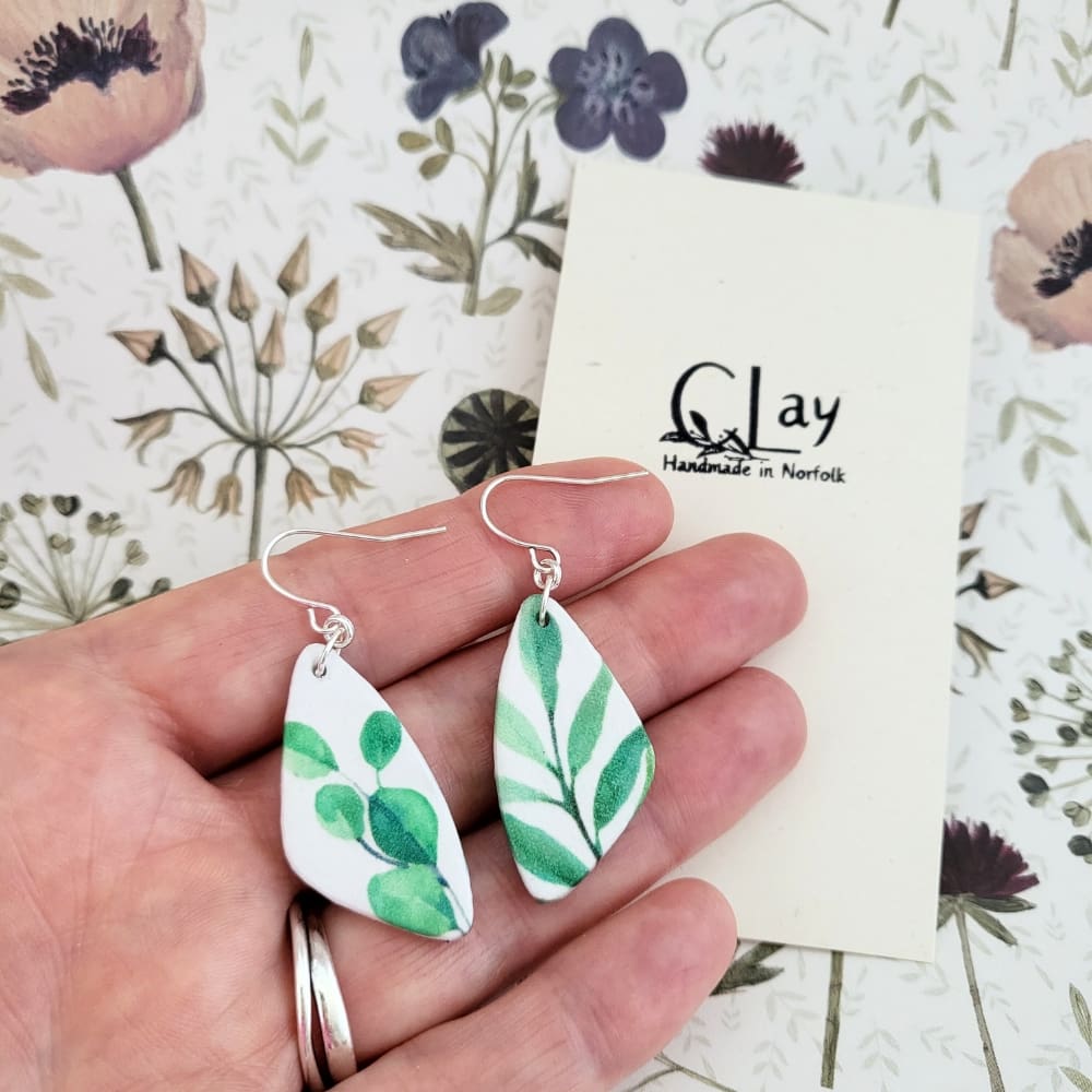 Teardrop shaped dangle earrings with a plant print