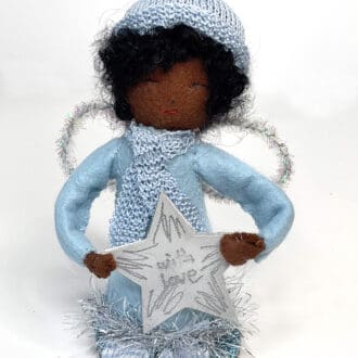 Brown-skinned Christmas shelf sitting angel in everyday clothes