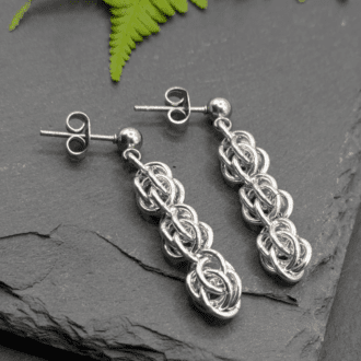 Chainmaille earrings made from small aluminium rings (silver in colour) woven in the sweet pea weave