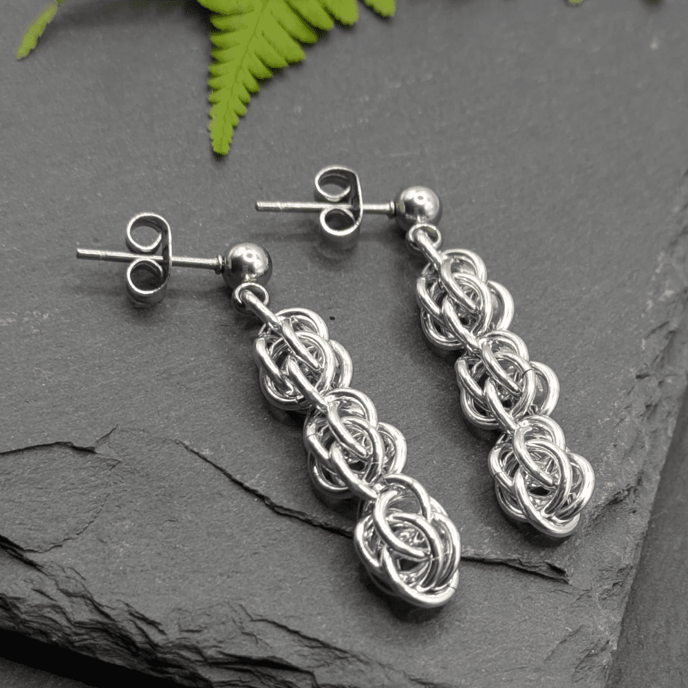 Chainmaille earrings made from small aluminium rings (silver in colour) woven in the sweet pea weave