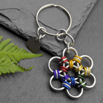 A keyring made into the shape of a flower. Made with larger silver rings and smaller rainbow coloured and silver rings