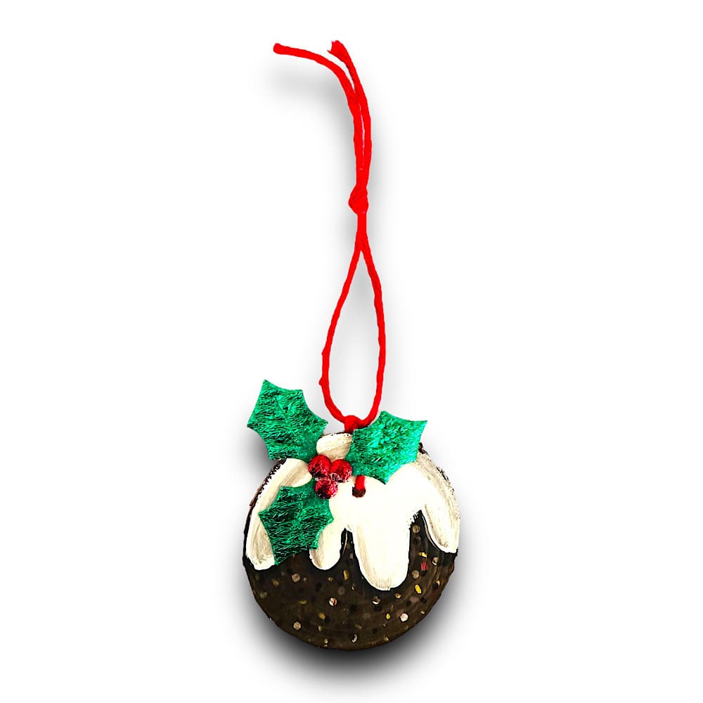 A Christmas pudding tree decoration, painted on a small wood slice with a holly and berry embellishment. it has red twine to hang on the tree with.