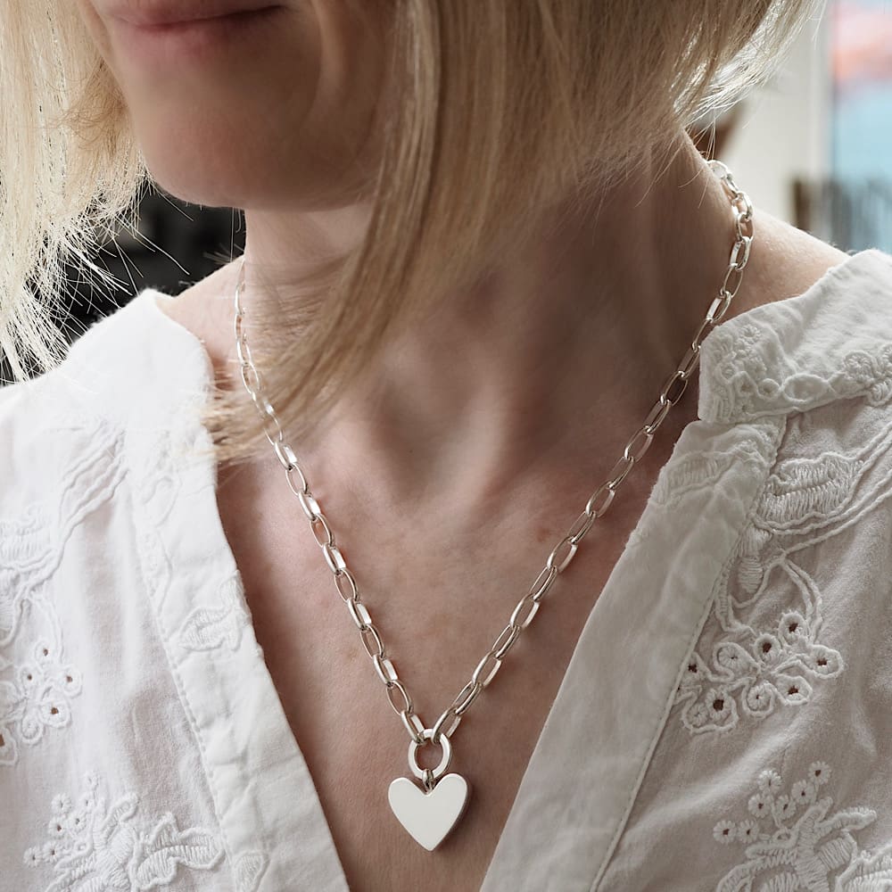 Chunky 2cm wide (3cm deep) solid silver heart suspended from a 12mm diameter circle link on a large loose linked 18in belcher chain modelled on a UK size 10