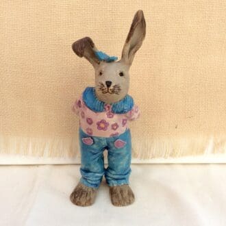 "rabbit-sculpture-wearing-jeans-and-purple-top"