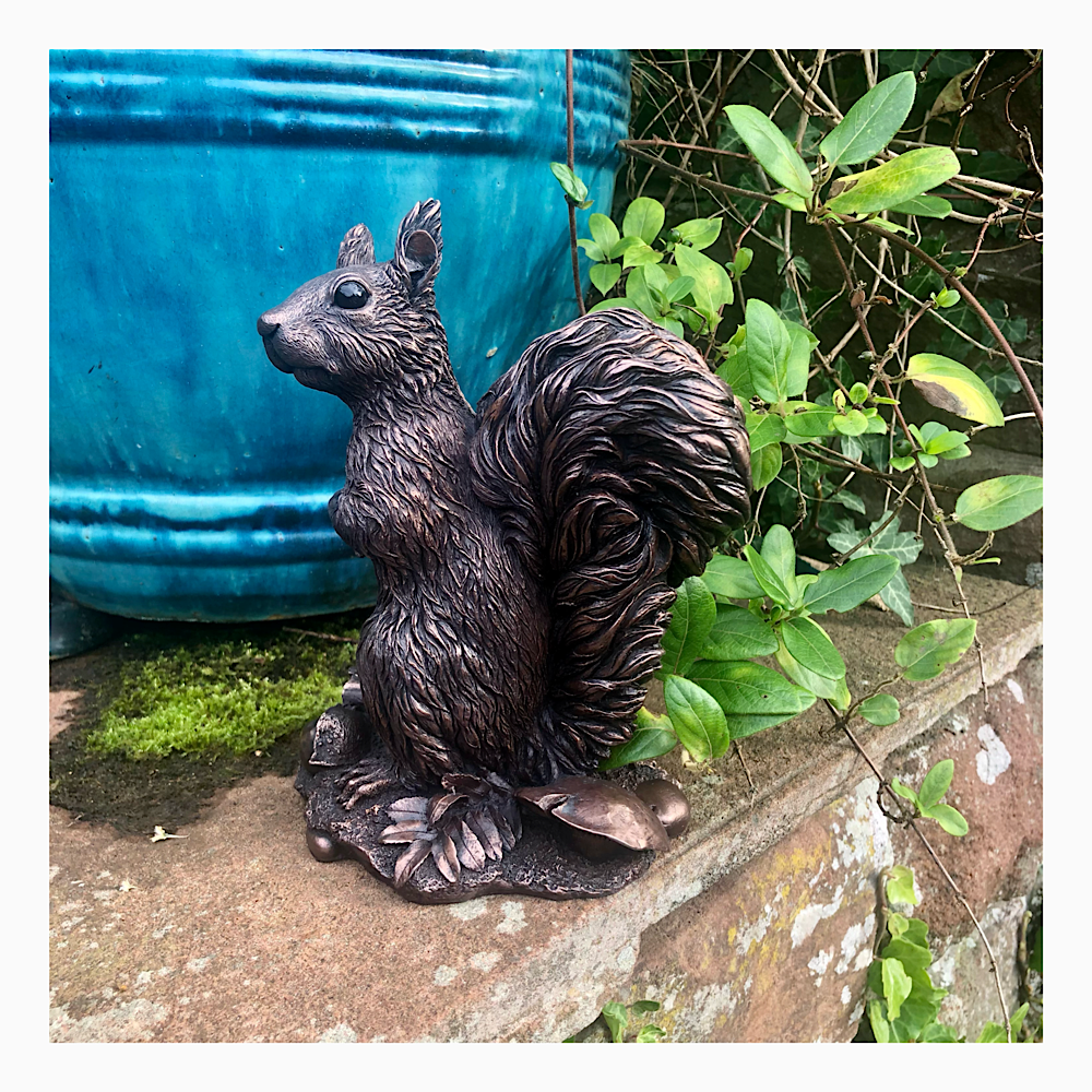 Realistic red squirrel sculpture in cold cast copper for home or garden by sculptor Kirsty Armstrong.