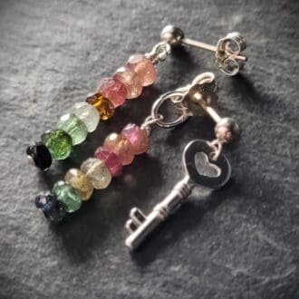 Key of Freedom Earrings. Asymmetrical earrings in sterling silver and watermelon tourmaline. One earring in the pair features a key charm as well as the multicoloured beads.