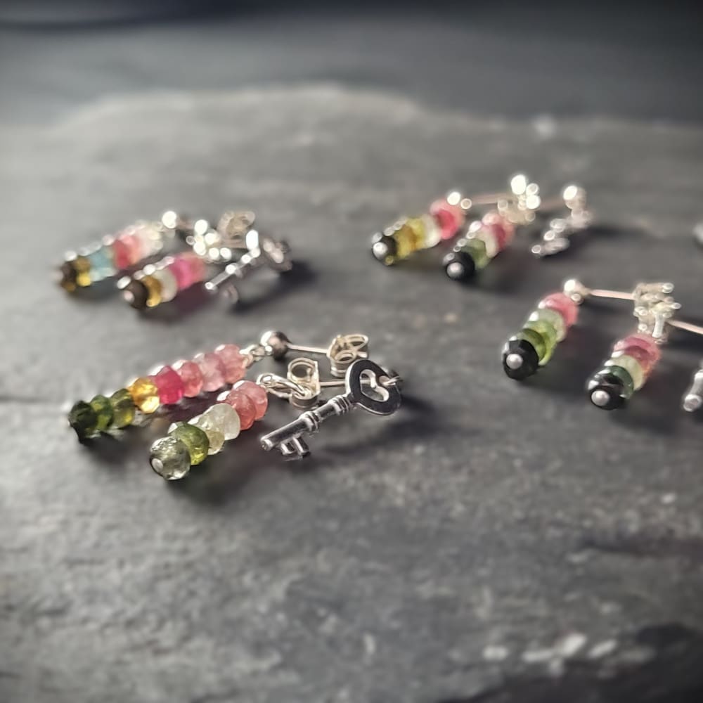 Key of Freedom Earrings. Asymmetrical earrings in sterling silver and watermelon tourmaline. One earring in the pair features a key charm as well as the multicoloured beads.