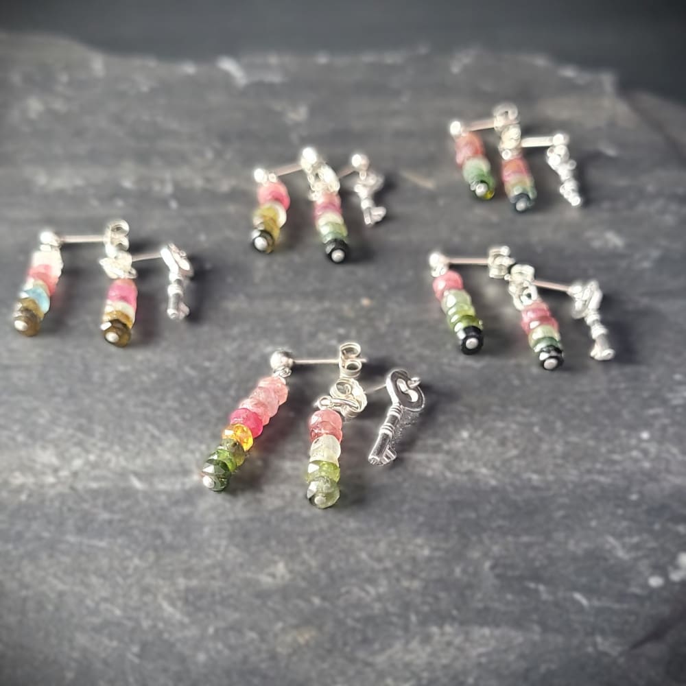 Key of Freedom Earrings. Asymmetrical earrings in sterling silver and watermelon tourmaline. One earring in the pair features a key charm as well as the multicoloured beads.