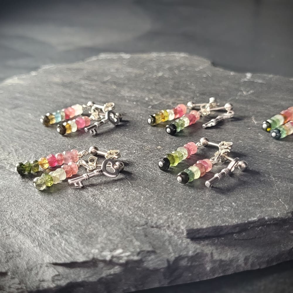 Key of Freedom Earrings. Asymmetrical earrings in sterling silver and watermelon tourmaline. One earring in the pair features a key charm as well as the multicoloured beads.