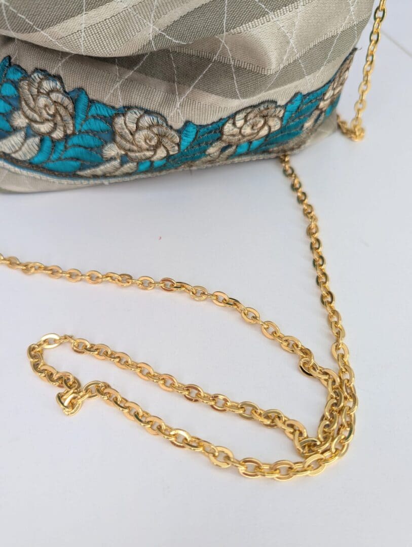 A gold wedding bag with chain and co-ordinating floral trim