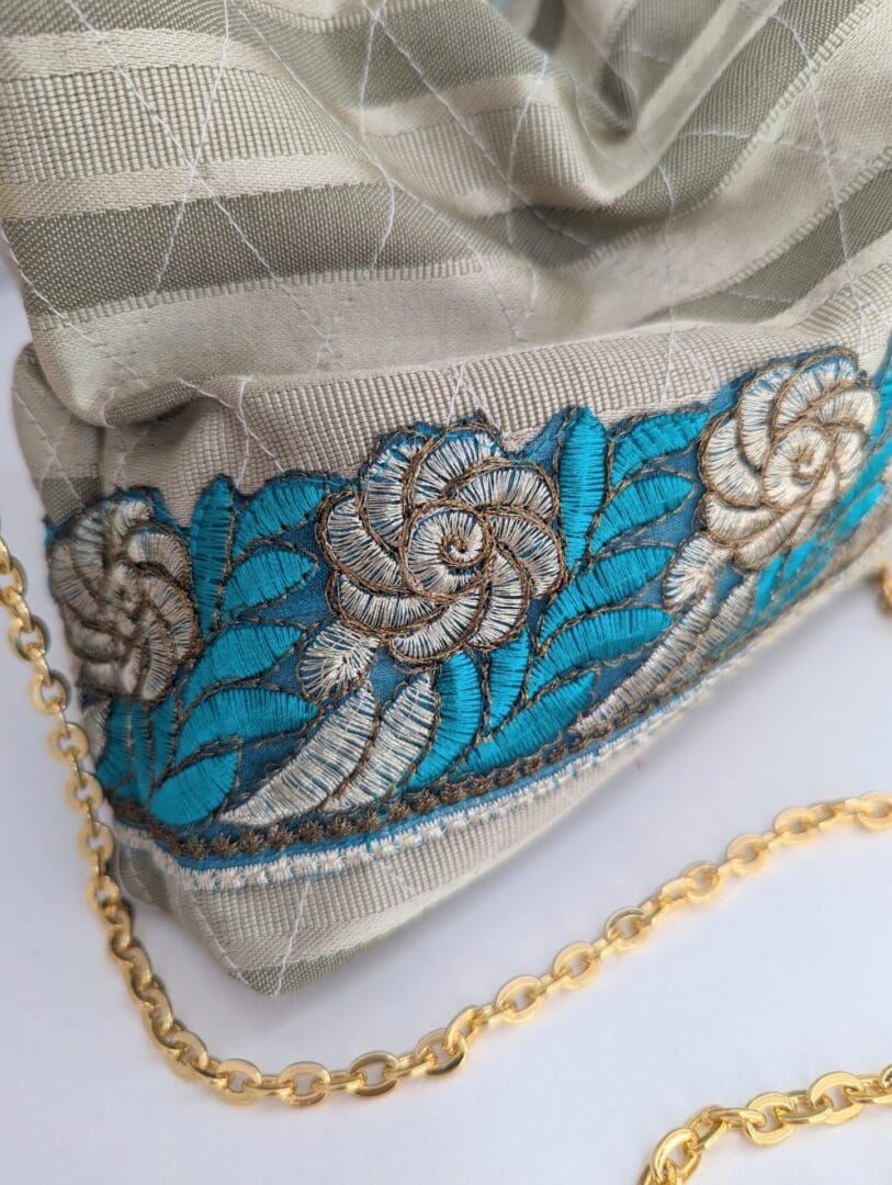 A small, lightweight evening bag embellished with a floral trim