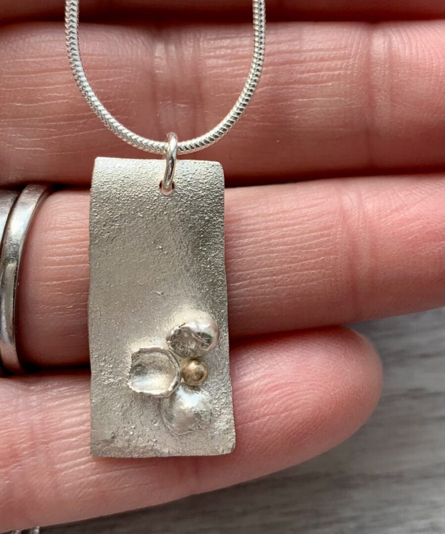 recycled silver and gold organic shape and texture pendant