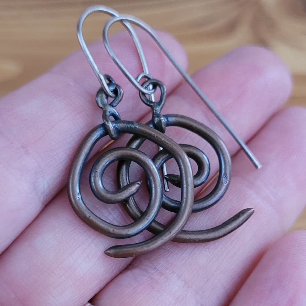 Spiral copper earrings with sterling silver hooks. Part of the Kenaz Collection.