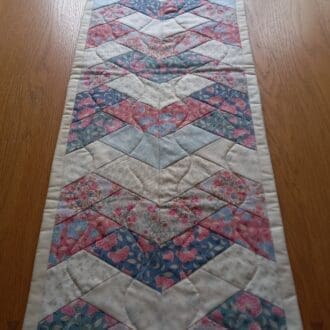 Pink and cream patchwork quilted table runner