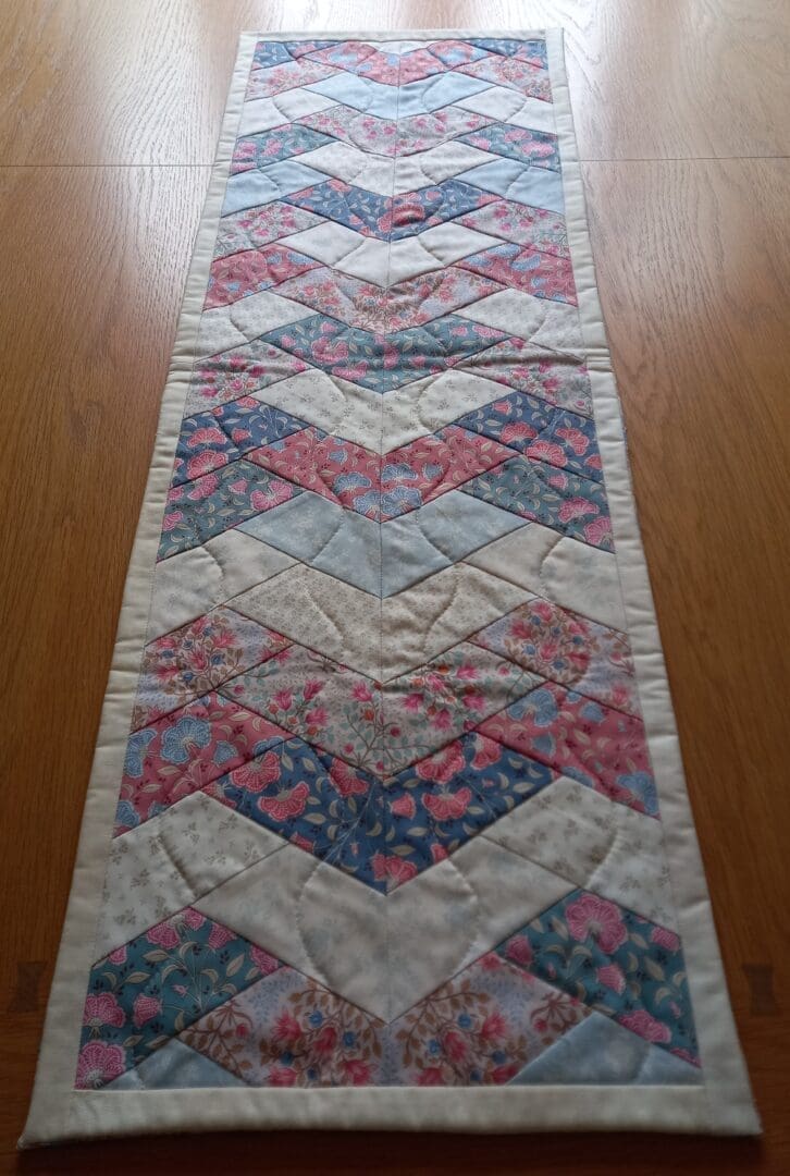 Pink and cream patchwork quilted table runner