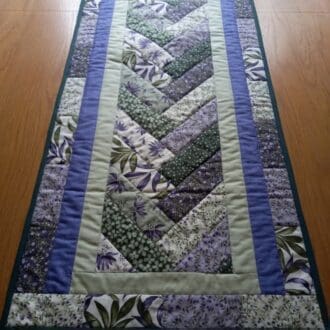 Purple and green patchwork quilted table runner