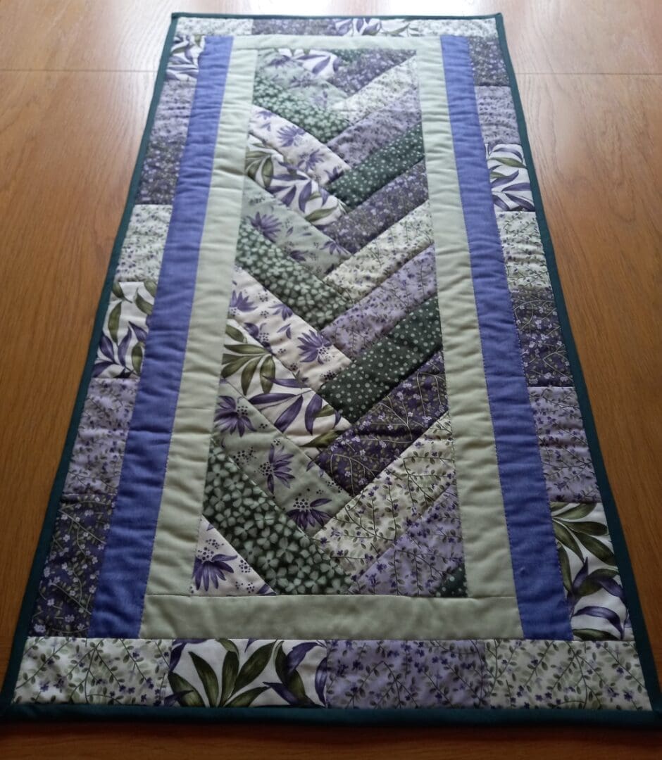 Purple and green patchwork quilted table runner