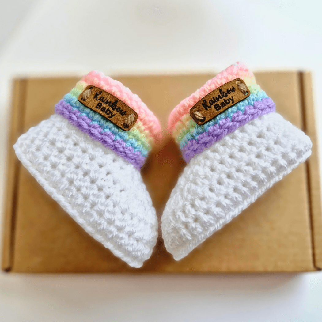 Rainbow baby booties with a leather tag, nade in sizes newborn, 0-3 and 3-6 months