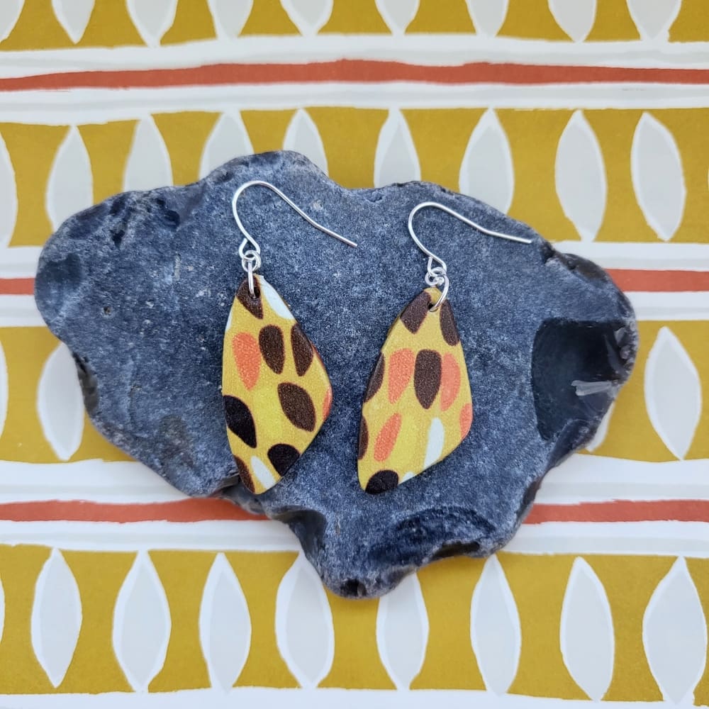 Teardrop shaped dangle earrings with a retro inspired print.