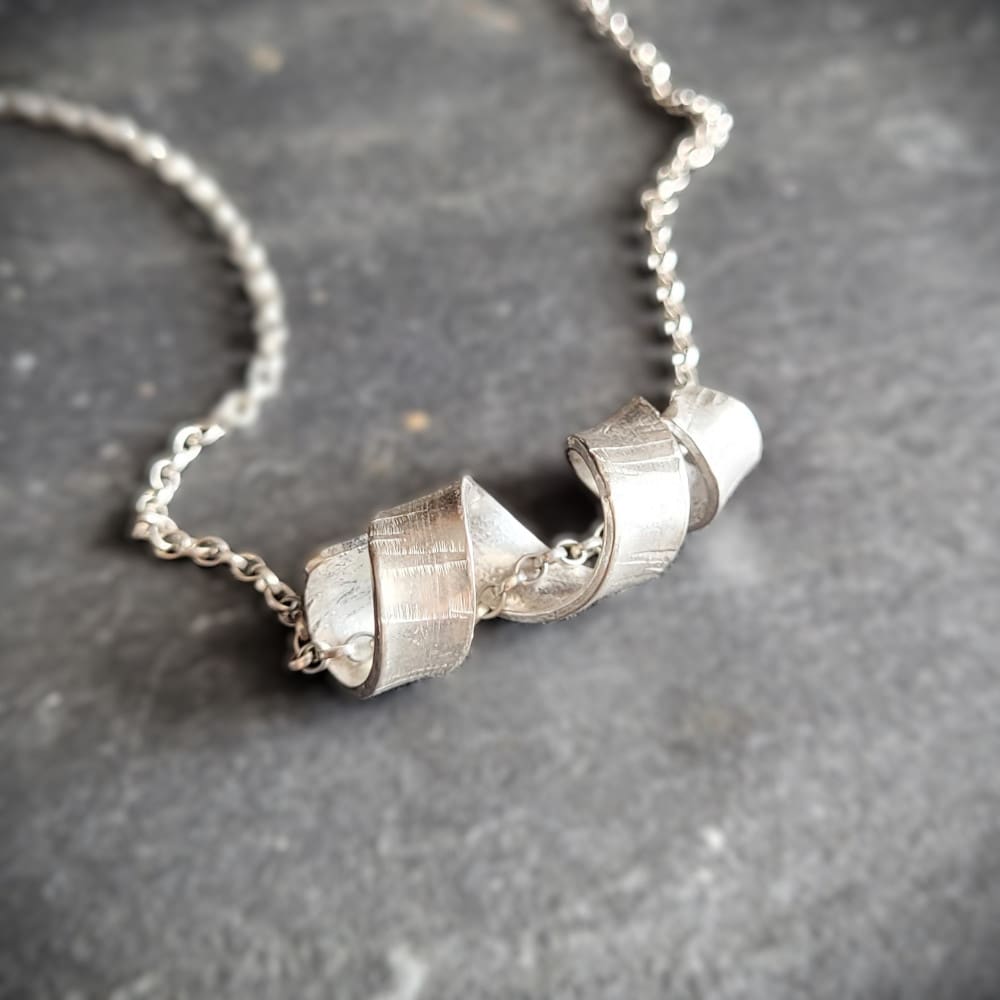 Sterling silver necklace with twisted spiral centrepiece reminiscent of silver birch tree bark.