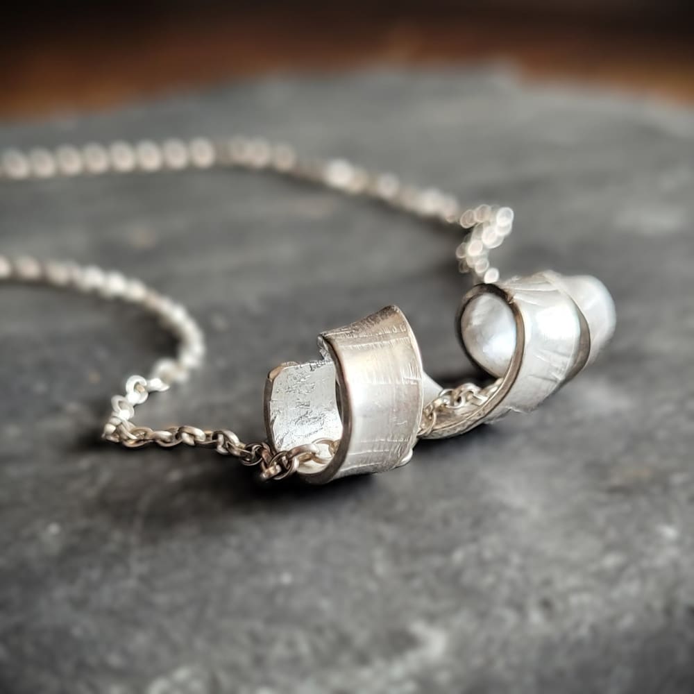 Sterling silver necklace with twisted spiral centrepiece reminiscent of silver birch tree bark.