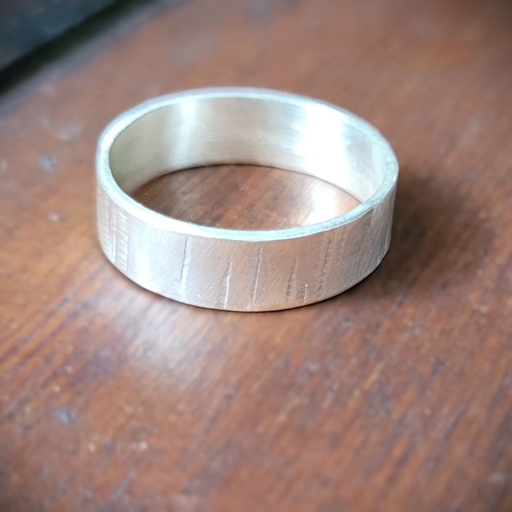 Simple sterling silver ring band with texture inspired by silver birch tree bark.