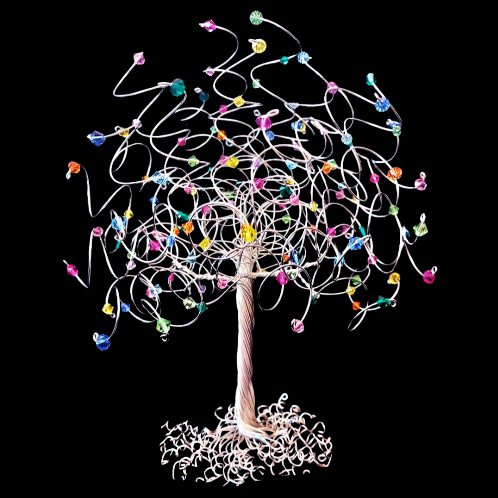 Silver wire tree decorated with multicoloured rainbow crystals on the branches.