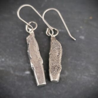 Sterling silver earrings in the shape of miniature standing stones.