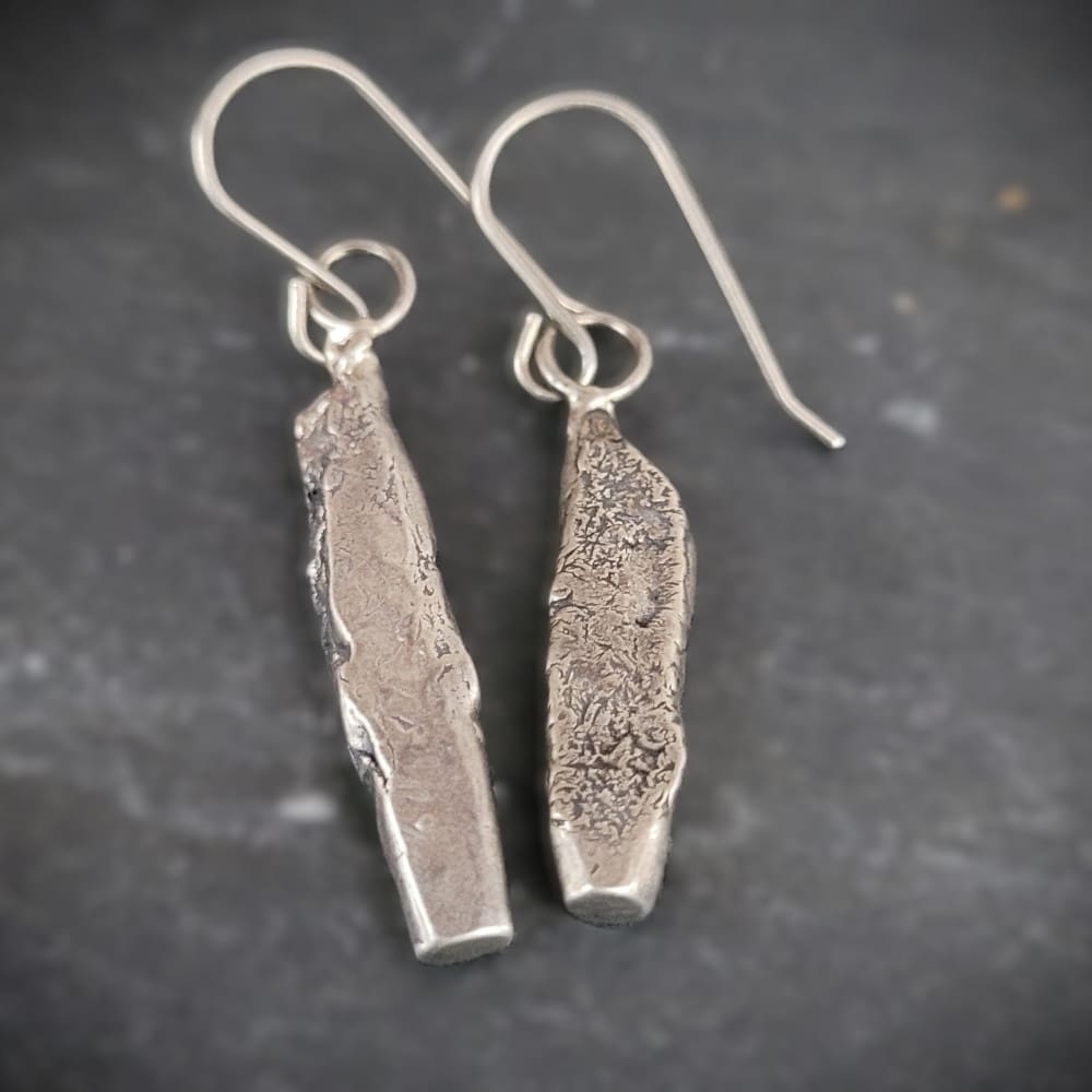 Sterling silver earrings in the shape of miniature standing stones.