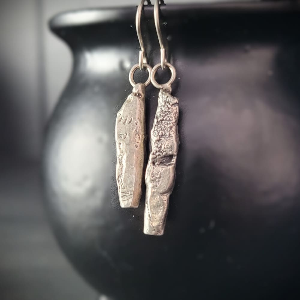 Sterling silver earrings in the shape of miniature standing stones.