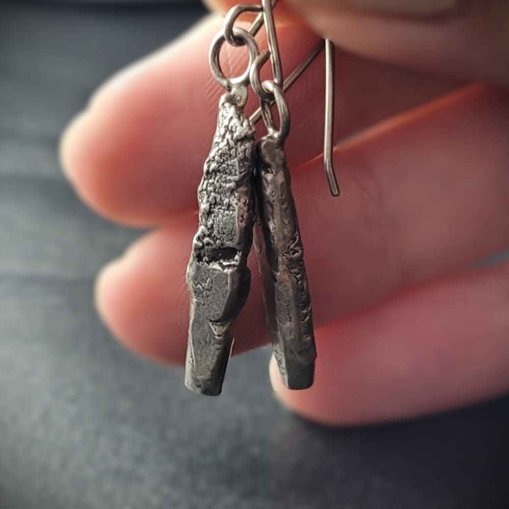 Sterling silver earrings in the shape of miniature standing stones.