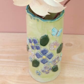 "green-vase-with-flowers"