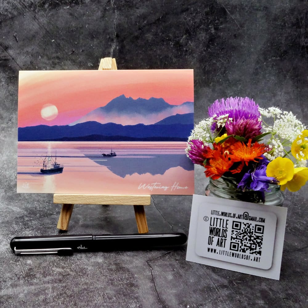 Image titled Westering Home showing an A6 size greetings card, blank inside, on a small easel depicting a sunset view towards the Cuillin's over the sea to Skye as the song goes.