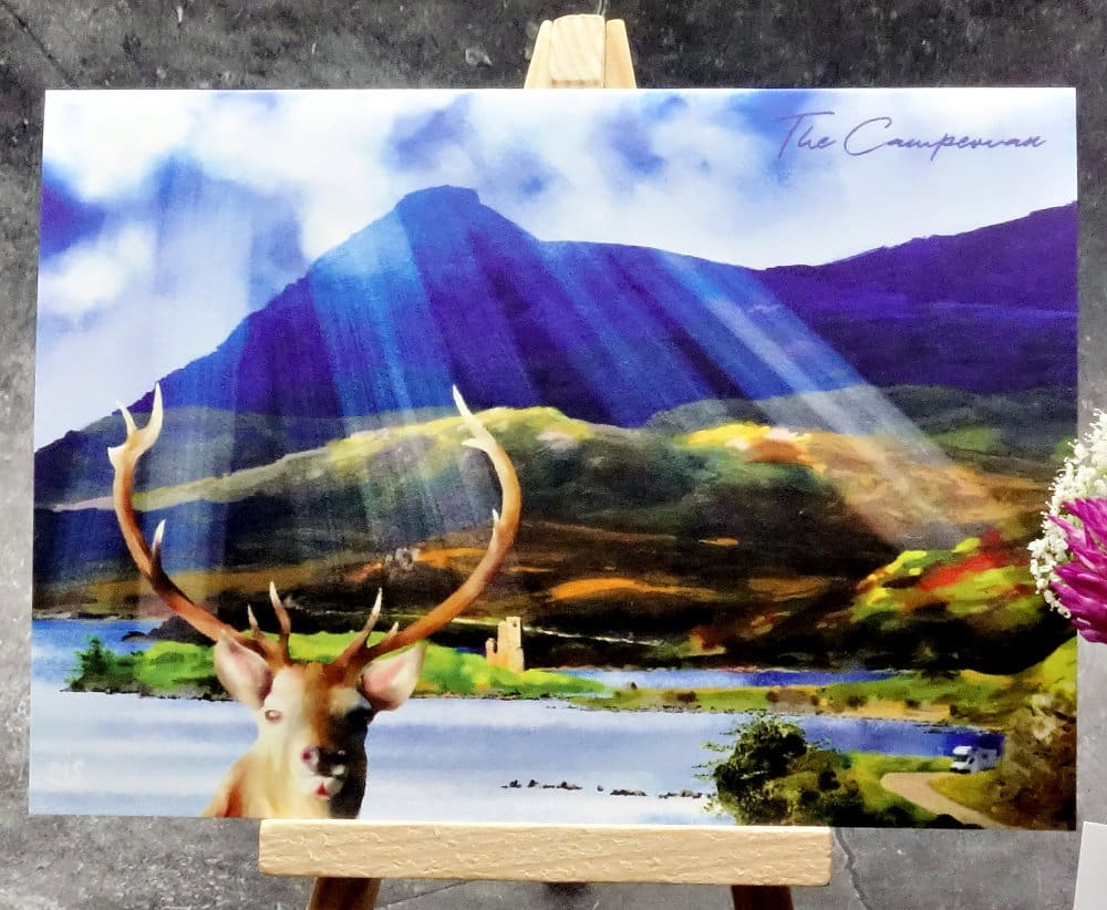 Larger image titled The Campervan showing an A6 size greetings card, blank inside, on a small easel depicting a view across loch Assynt to Ardvreck Castle and Quinag from a viewpoint on the A837.