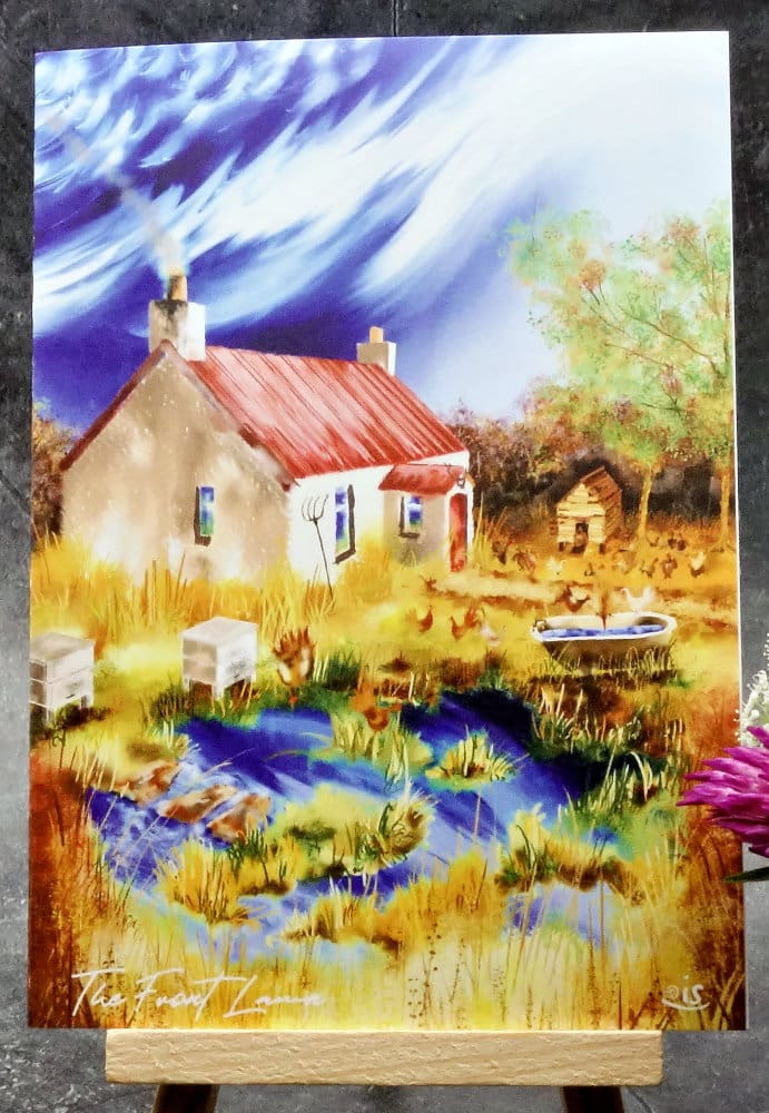 Larger image titled The Front Lawn an A6 size greetings card, blank inside, on a small easel depicting a view of an overgrown front lawn with hens and bees on an old highland croft.